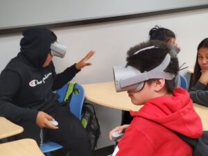 Students exploring collaborative projects in class in VR.